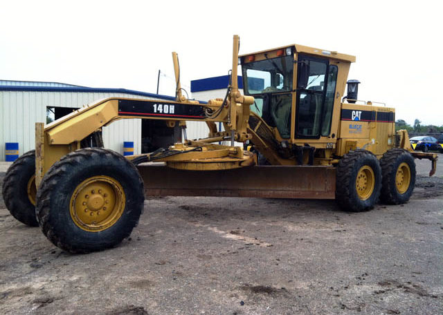 A Cat Yellow Truck With Digging Tool