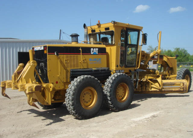 A Yellow Color Cat Truck With Ploughing Attachment