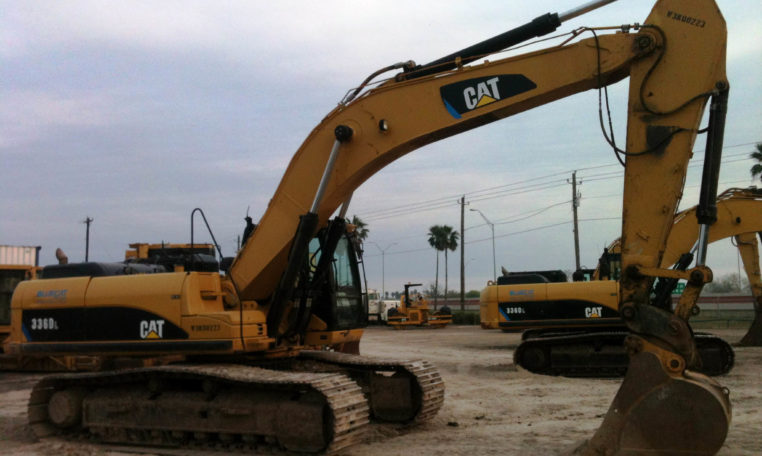An Excavator With Claw Resting on the Ground Side