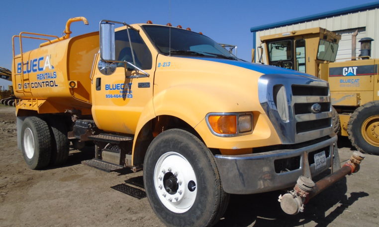 A Yellow Color Blue Cat Water Truck in Parking