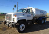 A GMC Heavy Duty Water Truck in White Front