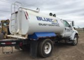 A White Water Truck With Blue Cat Written on Tank Back