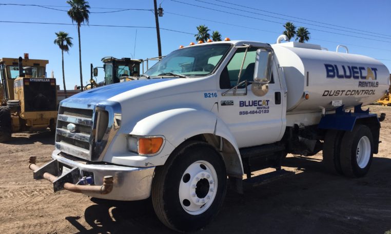 A White Color Blue Cat Water Truck in Parking Front Side