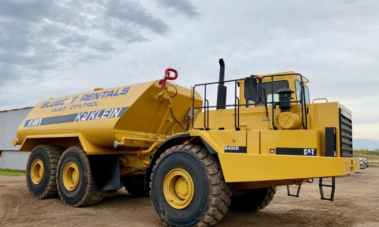 A Yellow Color Blue Cat Dust Control Vehical