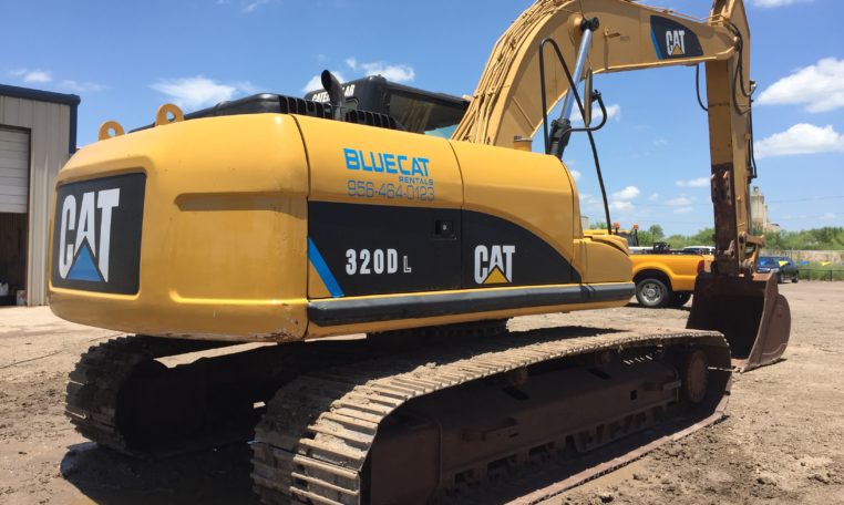 A Cat Excavator With Claw Attached Back